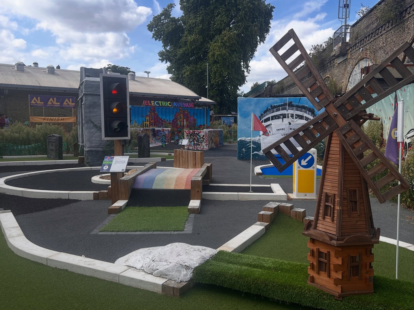 The built Putt n Play course in Brixton, with an oversized traffic light, a rainbow crossing ramp, the Brixton windmill and murals of Electric Avenue and the Empire Windrush