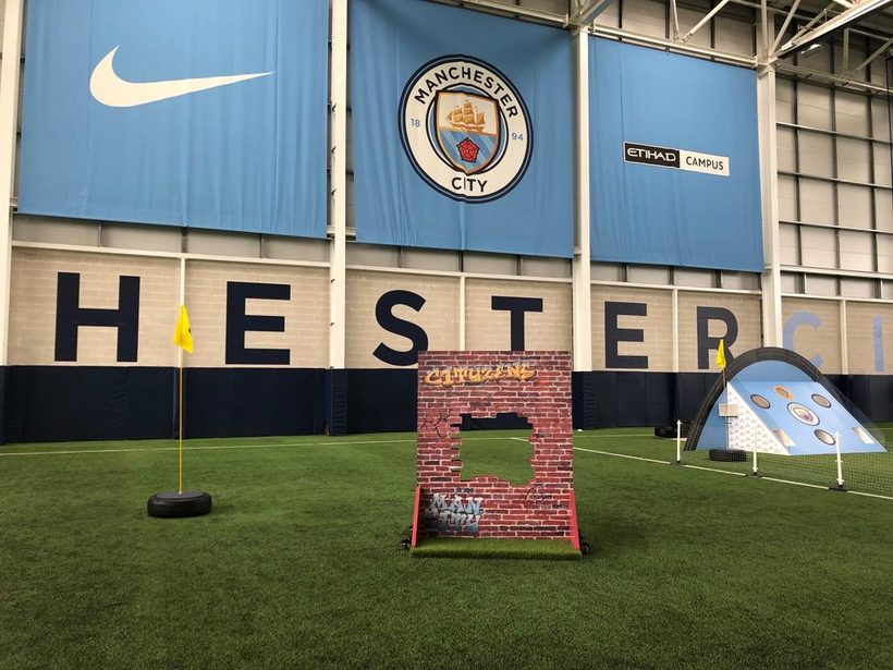 Brick wall obstacle with a cut-out target, tagged with Cityzens graffiti
